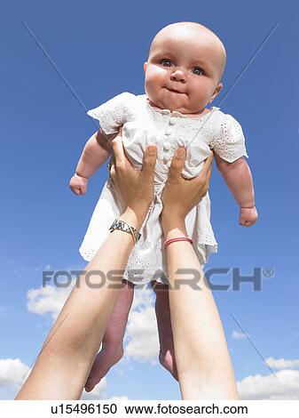 Stock Image - baby up in the air. Fotosearch