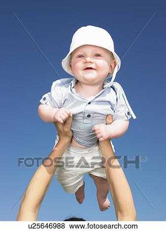 Stock Photo - baby up in the air. Fotosearch