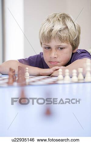 Boy playing chess View Large Photo Image Stock Photograph - Boy playing chess. Fotosearch