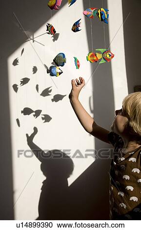 Stock Image - boy playing with mobile toy. Fotosearch