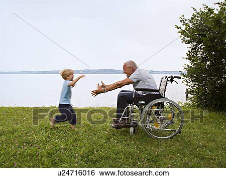 boy running into arms of senior man View Large Photo Image Stock Photograph - boy running into arms of senior man. Fotosearch
