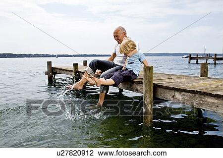 boy splashing with grandfather at lake View Large Photo Image Stock Image - boy splashing with grandfather at lake. Fotosearch