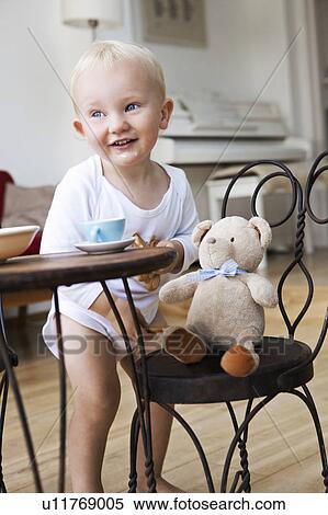 Stock Photography - Boy toddler at tea party with his teddy. Fotosearch