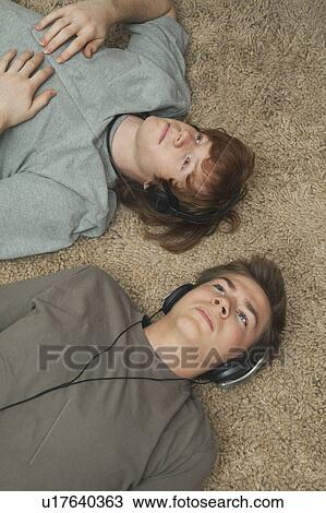 Stock Image - Boys listening to music. Fotosearch