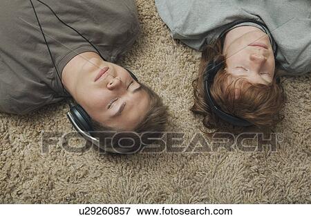 Stock Photo - Boys listening to music. Fotosearch
