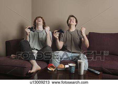 Stock Image - Boys playing video game. Fotosearch