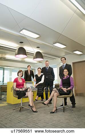 Stock Image - Business colleagues pose for photograph. Fotosearch