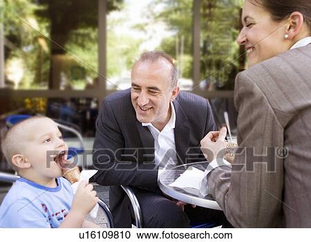 business couple with son in outdoor cafe View Large Photo Image Stock Image - business couple with son in outdoor cafe. Fotosearch