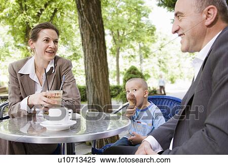 business couple with son in outdoor cafe View Large Photo Image Stock Photography - business couple with son in outdoor cafe. Fotosearch