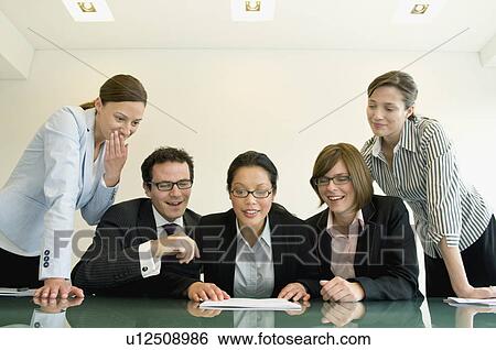 Business group reading some data View Large Photo Image Stock Photograph - Business group reading some data. Fotosearch