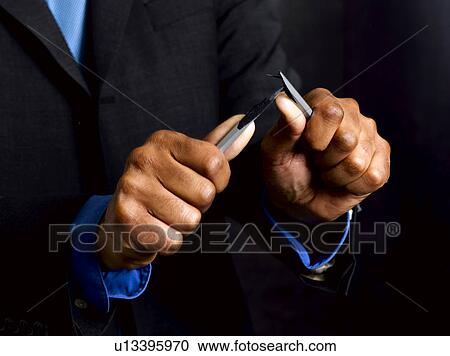 Stock Image - Business man breaking pencil in half. Fotosearch