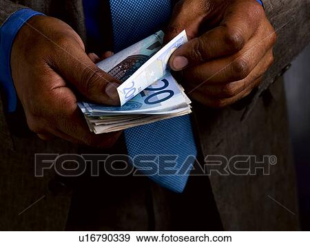 Stock Photo - Business man counting euro bills. Fotosearch