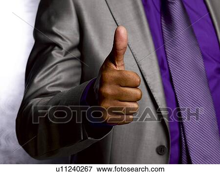 Stock Photo - Business man giving thumbs up. Fotosearch