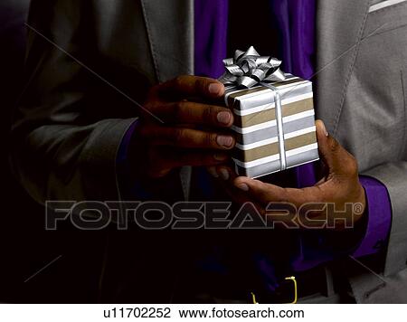 Business man holding gift View Large Photo Image Stock Image - Business man holding gift. Fotosearch