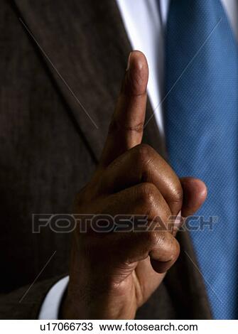 Business man holding one finger up View Large Photo Image Stock Image - Business man holding one finger up. Fotosearch