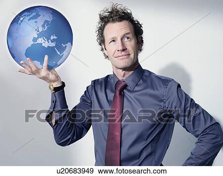Stock Photo - Business man holds up globe. Fotosearch