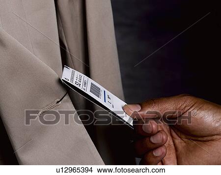 Business man looking at price tag View Large Photo Image Picture - Business man looking at price tag. Fotosearch