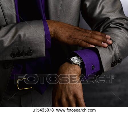 Business man looking at watch View Large Photo Image Stock Photo - Business man looking at watch. Fotosearch