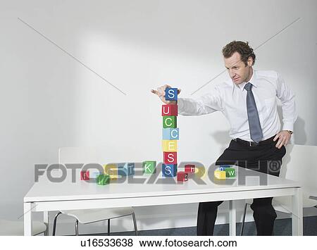 Business man playing with blocks View Large Photo Image Stock Photo - Business man playing with blocks. Fotosearch