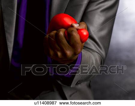 Stock Photo - Business man squeezing stress ball. Fotosearch
