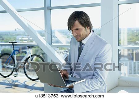 Stock Image - business man with computer. Fotosearch