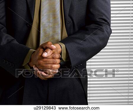 Business man wringing hands together View Large Photo Image Stock Image - Business man wringing hands together. Fotosearch