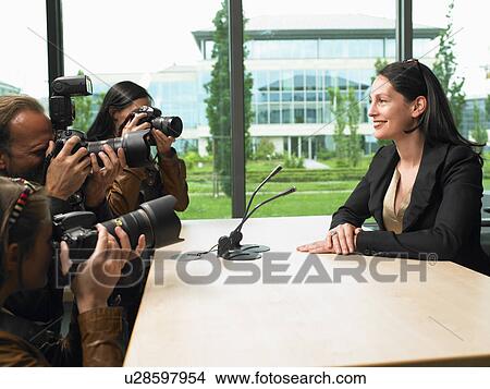 Picture - Business woman giving a conference. Fotosearch