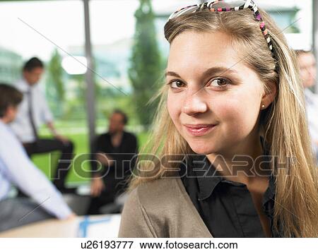 Stock Photo - Business woman looking at camera. Fotosearch
