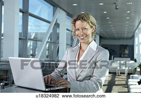 Stock Image - business woman with computer. Fotosearch