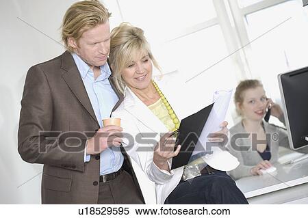 Businessman and laughing woman standing View Large Photo Image Stock Photography - Businessman and laughing woman standing. Fotosearch