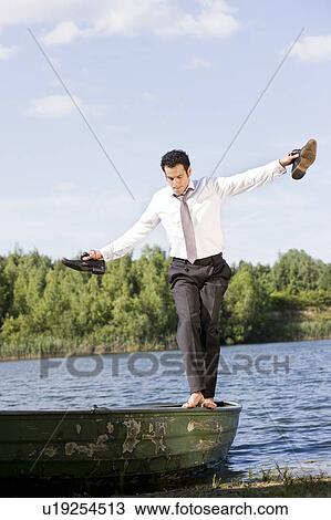 businessman balancing on rowboat View Large Photo Image Stock Image - businessman balancing on rowboat. Fotosearch
