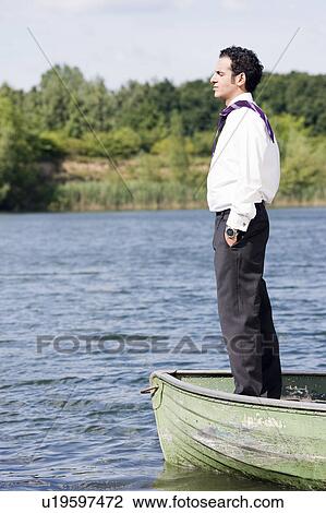 businessman in standing in rowboat View Large Photo Image Stock Image - businessman in standing in rowboat. Fotosearch