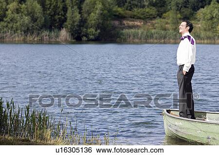 Stock Photograph - businessman in standing in rowboat. Fotosearch