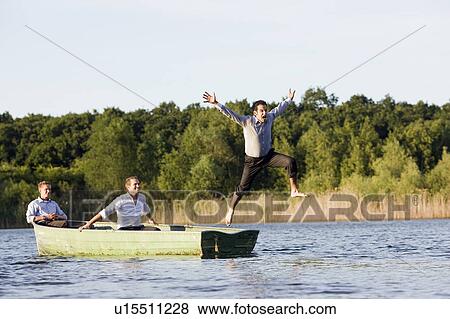 businessman jumping of rowboat View Large Photo Image Stock Photo - businessman jumping of rowboat. Fotosearch