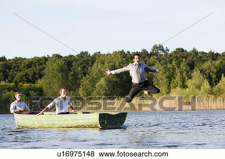 businessman jumping of rowboat View Large Photo Image Stock Photo - businessman jumping of rowboat. Fotosearch
