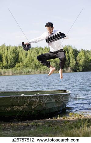 businessman jumping on rowboat View Large Photo Image Stock Image - businessman jumping on rowboat. Fotosearch