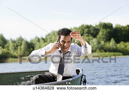 businessman on the phone in rowboat View Large Photo Image Stock Photo - businessman on the phone in rowboat. Fotosearch