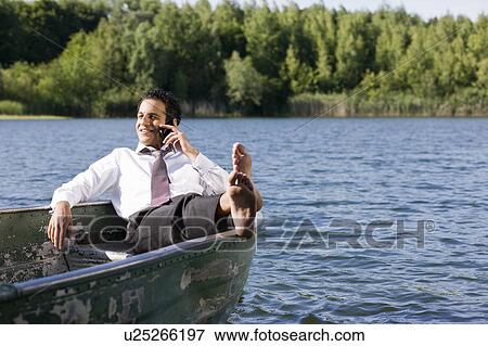 businessman on the phone in rowboat View Large Photo Image Stock Photo - businessman on the phone in rowboat. Fotosearch