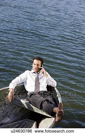 Stock Photograph - businessman on the phone in rowboat. Fotosearch