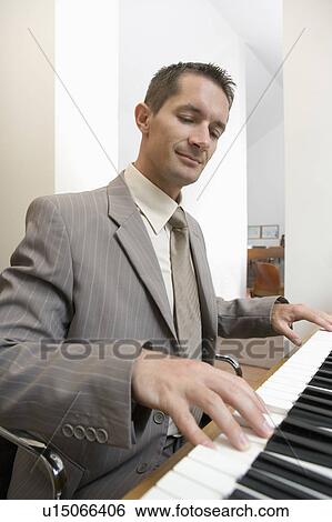 Stock Photograph - businessman playing piano. Fotosearch