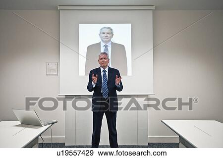 Businessman presenting in a boardroom View Large Photo Image Stock Photo - Businessman presenting in a boardroom. Fotosearch
