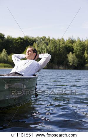 businessman relaxing in rowboat View Large Photo Image Stock Image - businessman relaxing in rowboat. Fotosearch