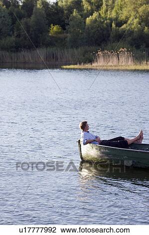 businessman relaxing in rowboat View Large Photo Image Stock Image - businessman relaxing in rowboat. Fotosearch