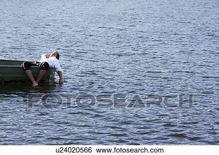 Stock Photograph - businessman relaxing in rowboat. Fotosearch