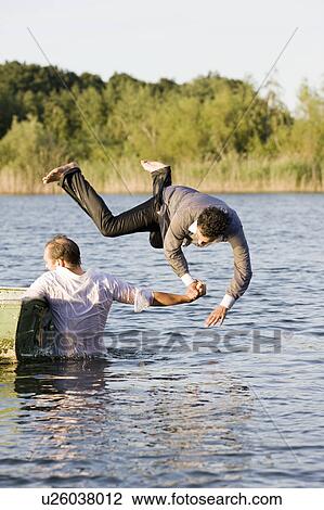 businessman throwing friend in water View Large Photo Image Stock Image - businessman throwing friend in water. Fotosearch