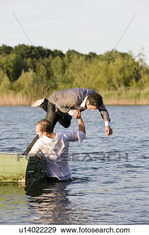 businessman throwing friend in water View Large Photo Image Stock Photo - businessman throwing friend in water. Fotosearch
