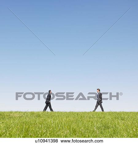 businessmen walking in field View Large Photo Image Stock Photo - businessmen walking in field. Fotosearch