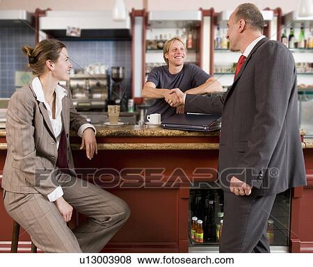businesspeople shaking hands with barkee View Large Photo Image Stock Photo - businesspeople shaking hands with barkee. Fotosearch