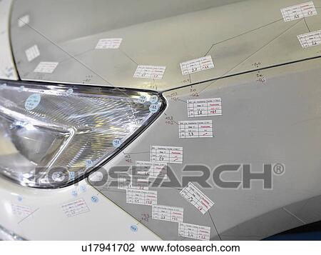 Stock Image - Car Headlight And Stickers In Factory. Fotosearch