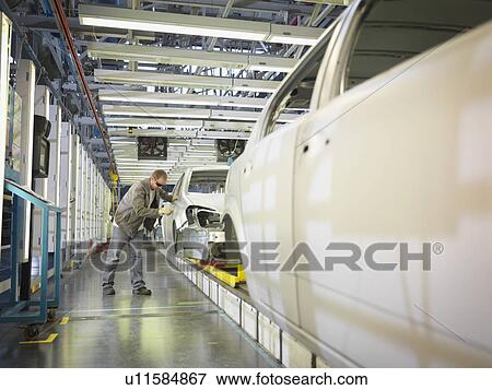 Stock Photo - Car Plant Worker On Production Line. Fotosearch